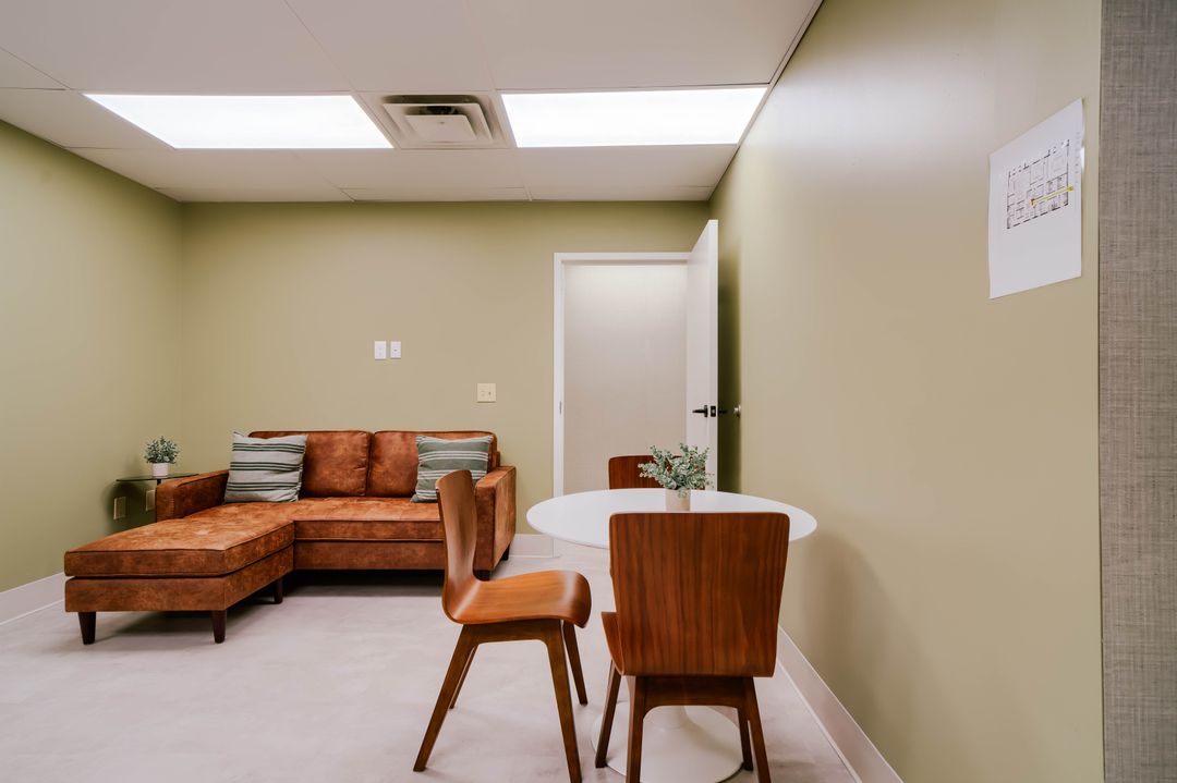 Brown sofa and round conversation table in Dove Recovery’s lounge