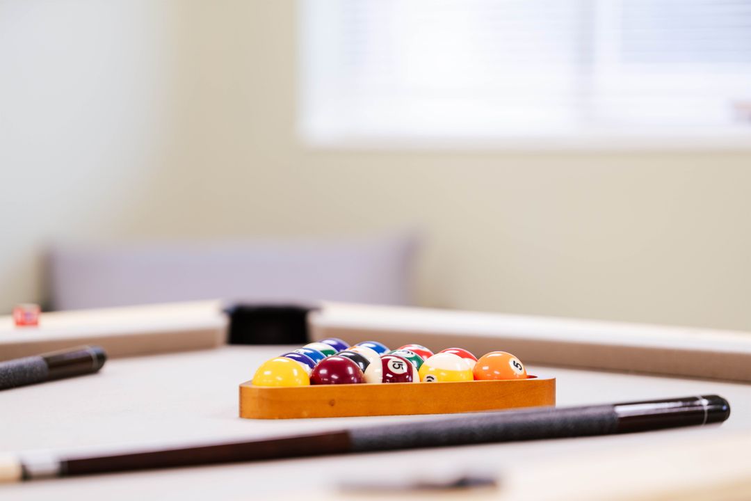 Pool table and colorful billiard balls in Dove Recovery’s recreation space