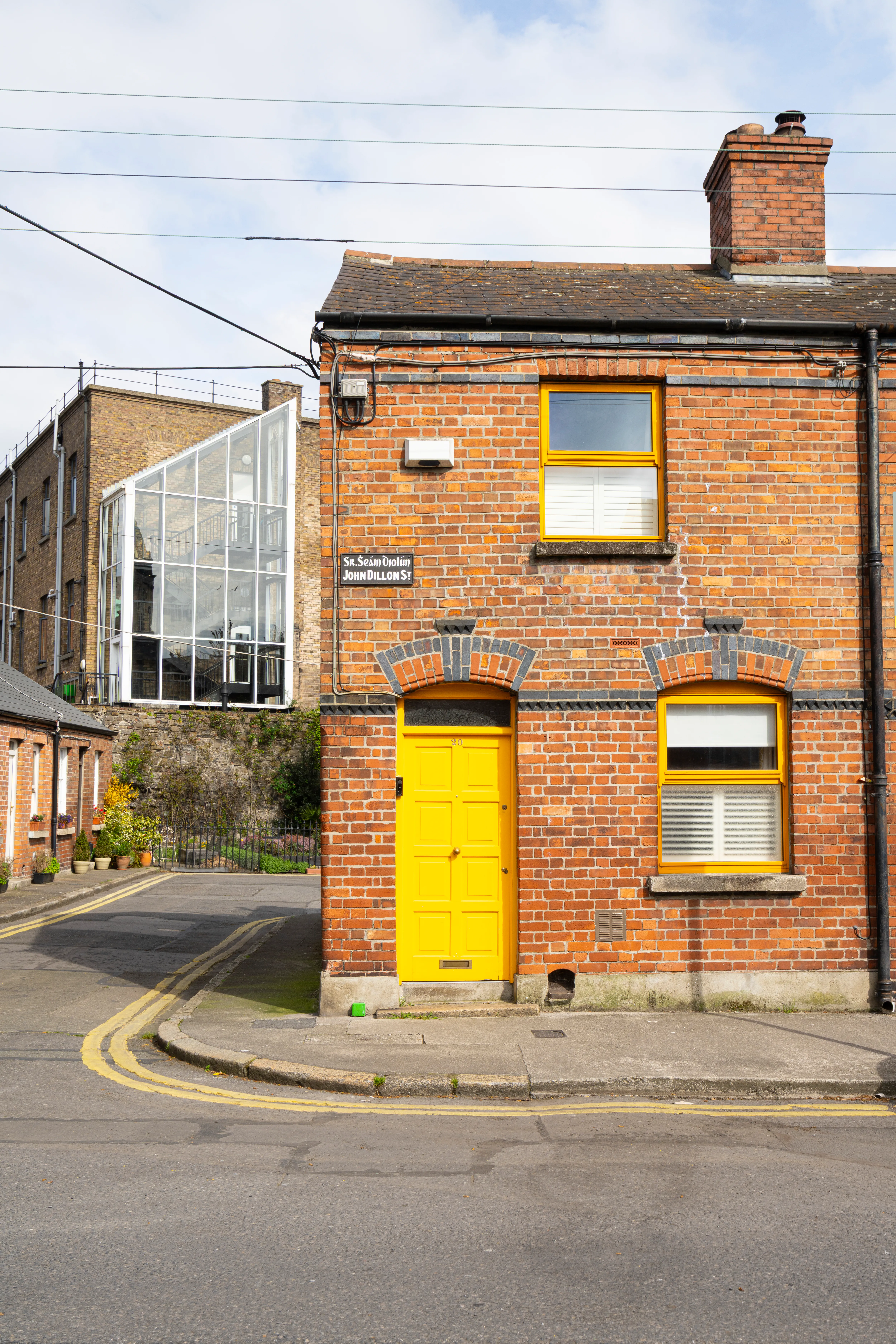 Red-brick Dublin house with a yellow door and window frames