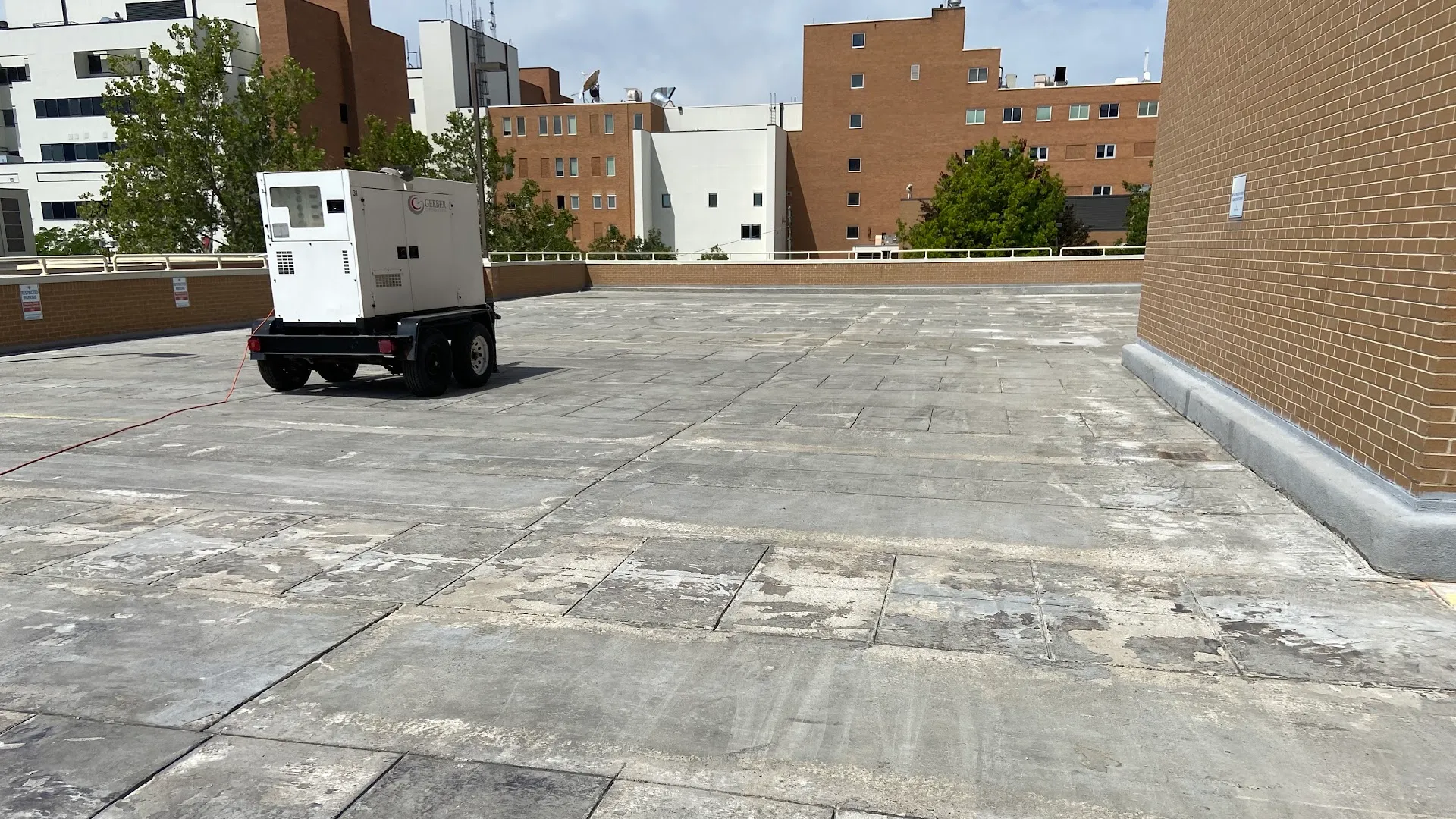 Before: a worn, patched parking garage deck with exposed and uneven concrete.