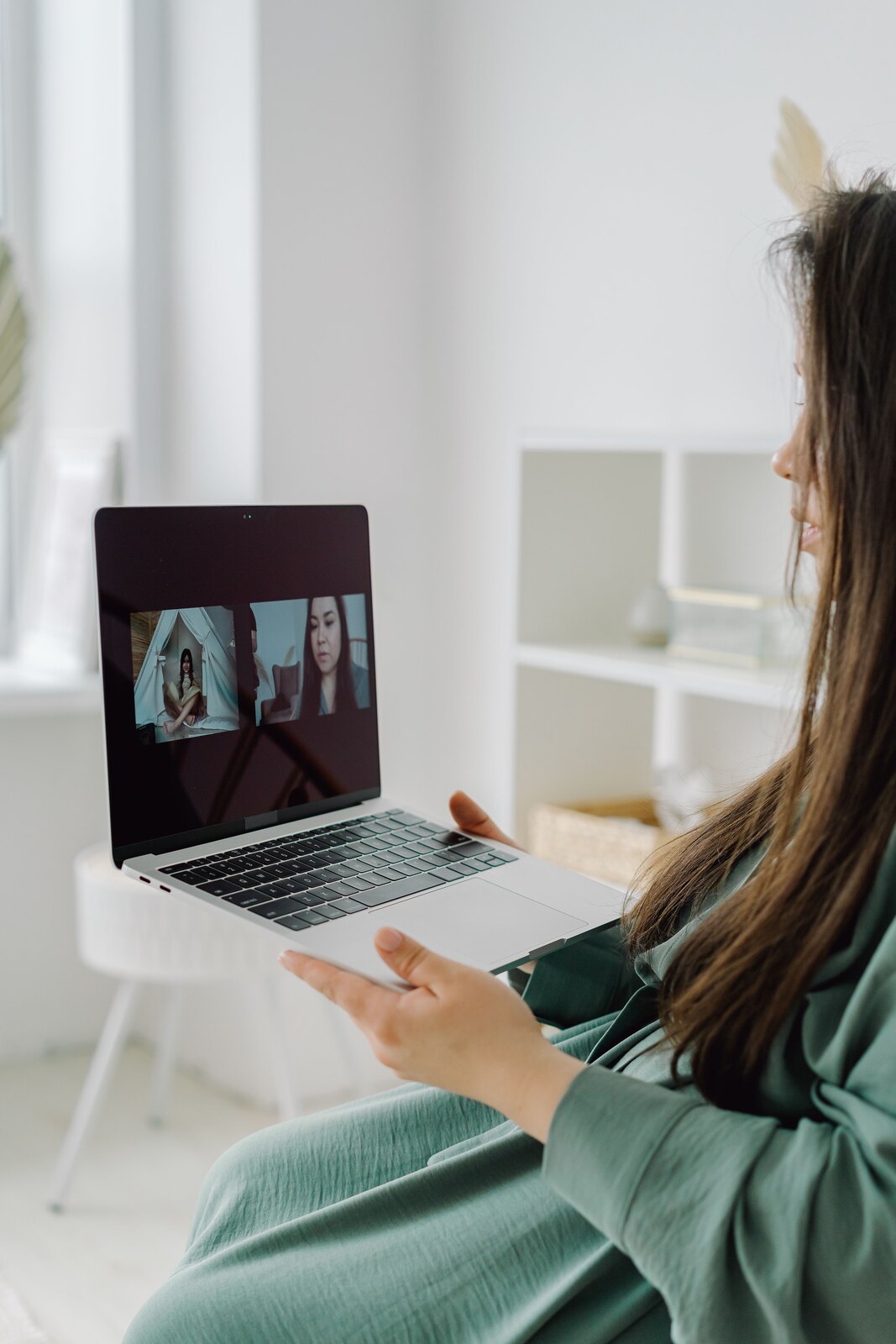 Illustrative stock photo of a person having a video conversation from home