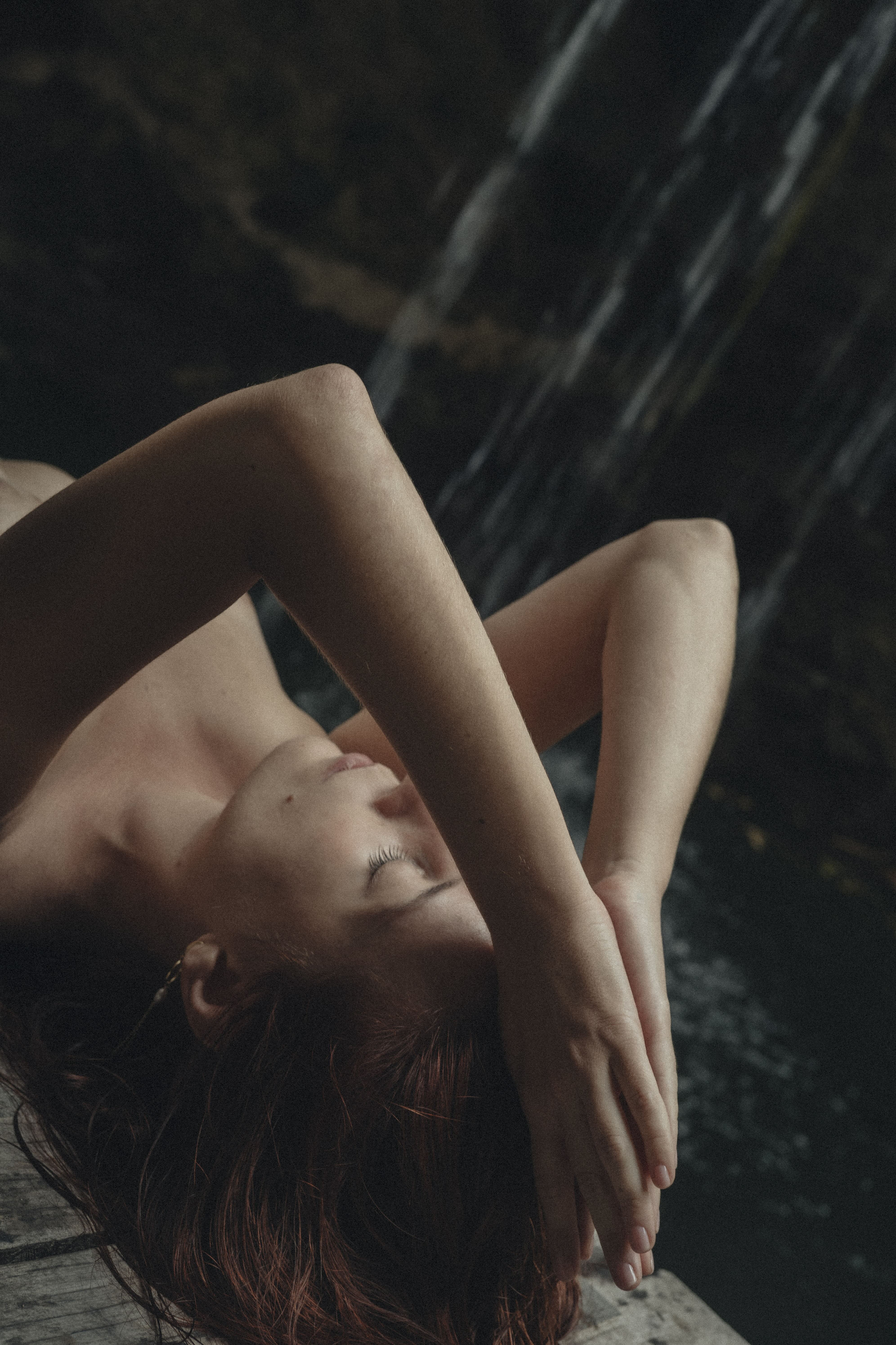 Delfina resting beside a waterfall