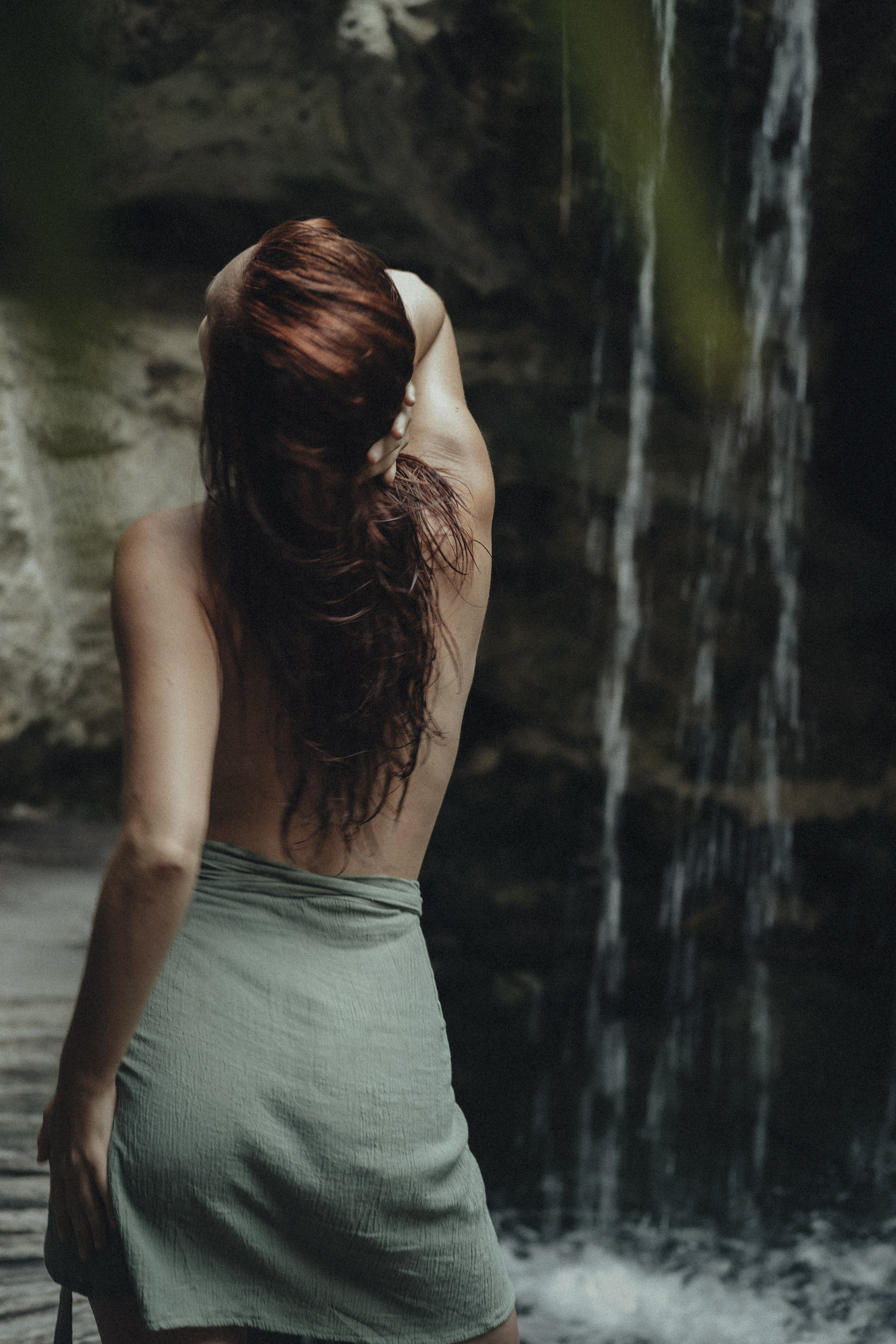 Delfina beside a waterfall