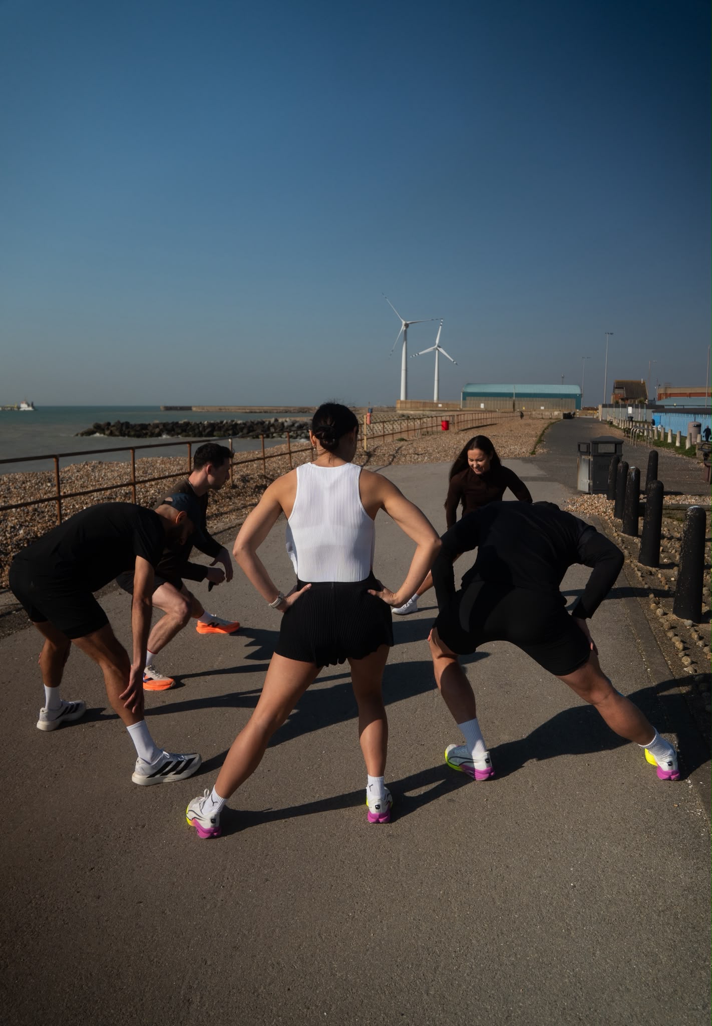 Falcon Performance runners stretching before a run