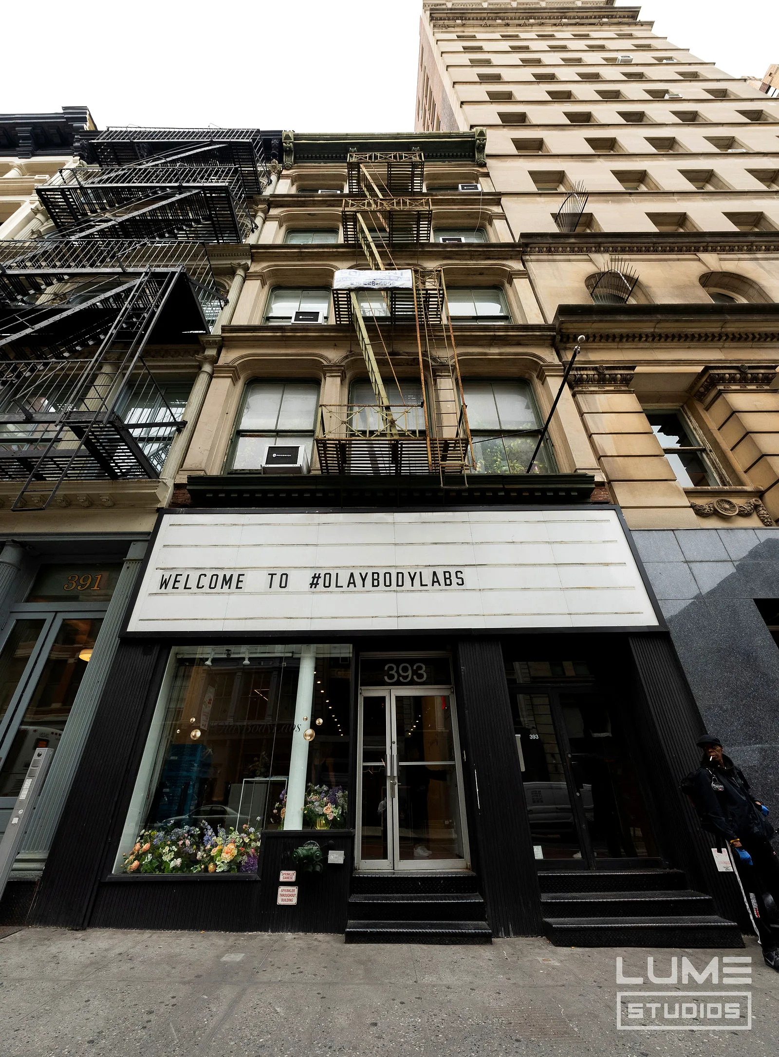 The LUME Studios street-facing marquee on Broadway during a corporate takeover