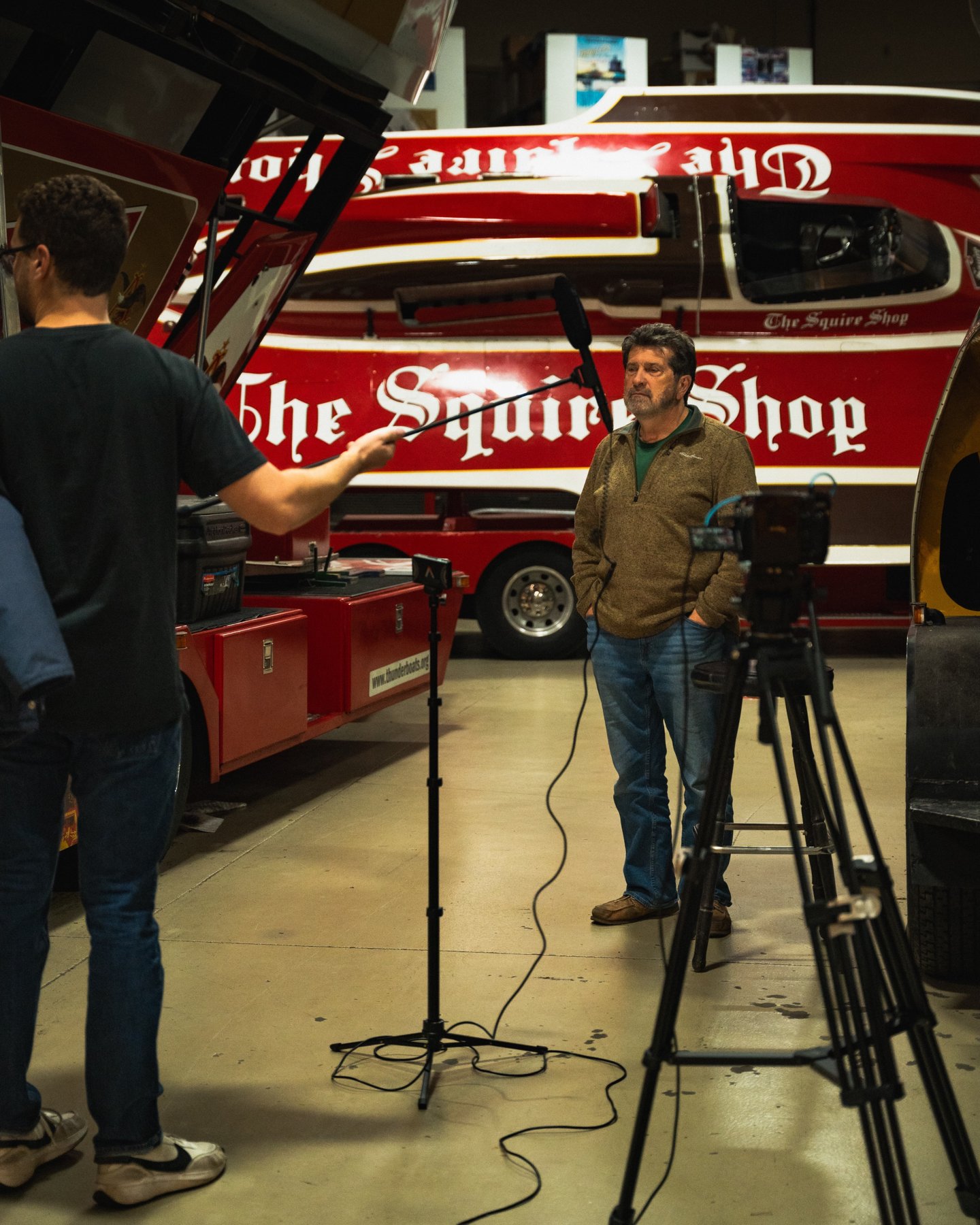 Engle Digital crew filming an interview beside a racing boat in Kent, Washington