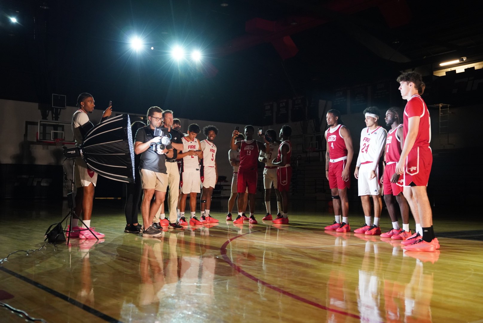 The crew filming a basketball team on the court