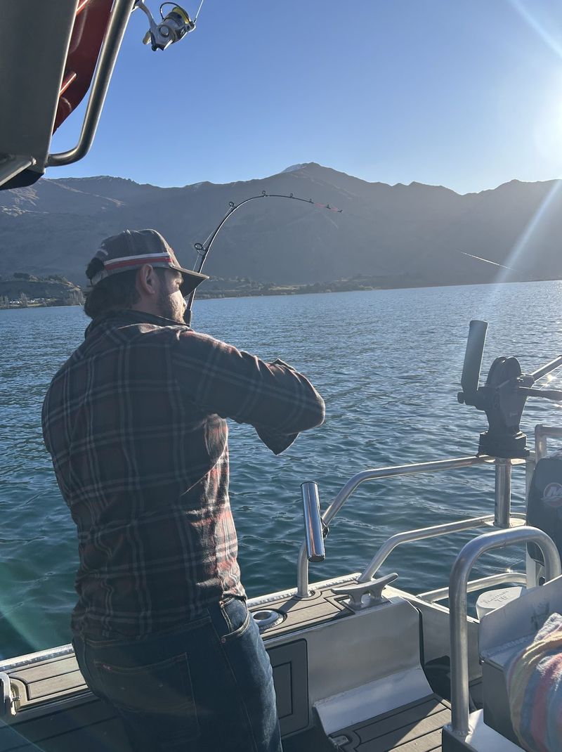 Guide casting a line at golden hour on Lake Wānaka