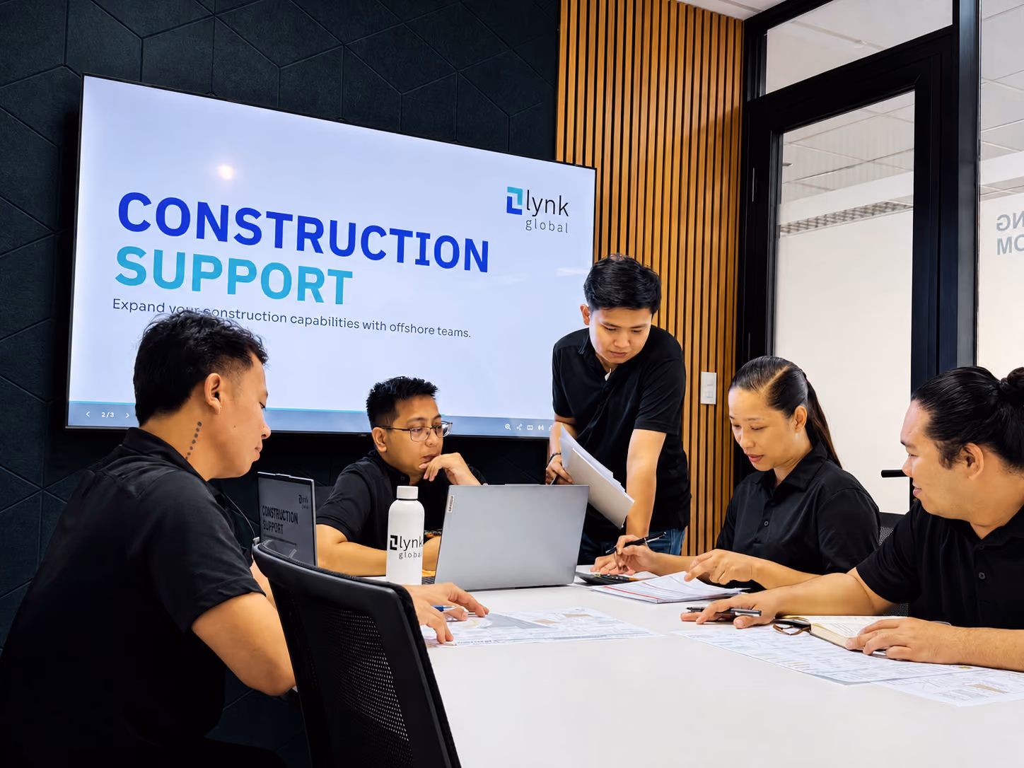 Lynk colleagues reviewing project documents together at the Manila office
