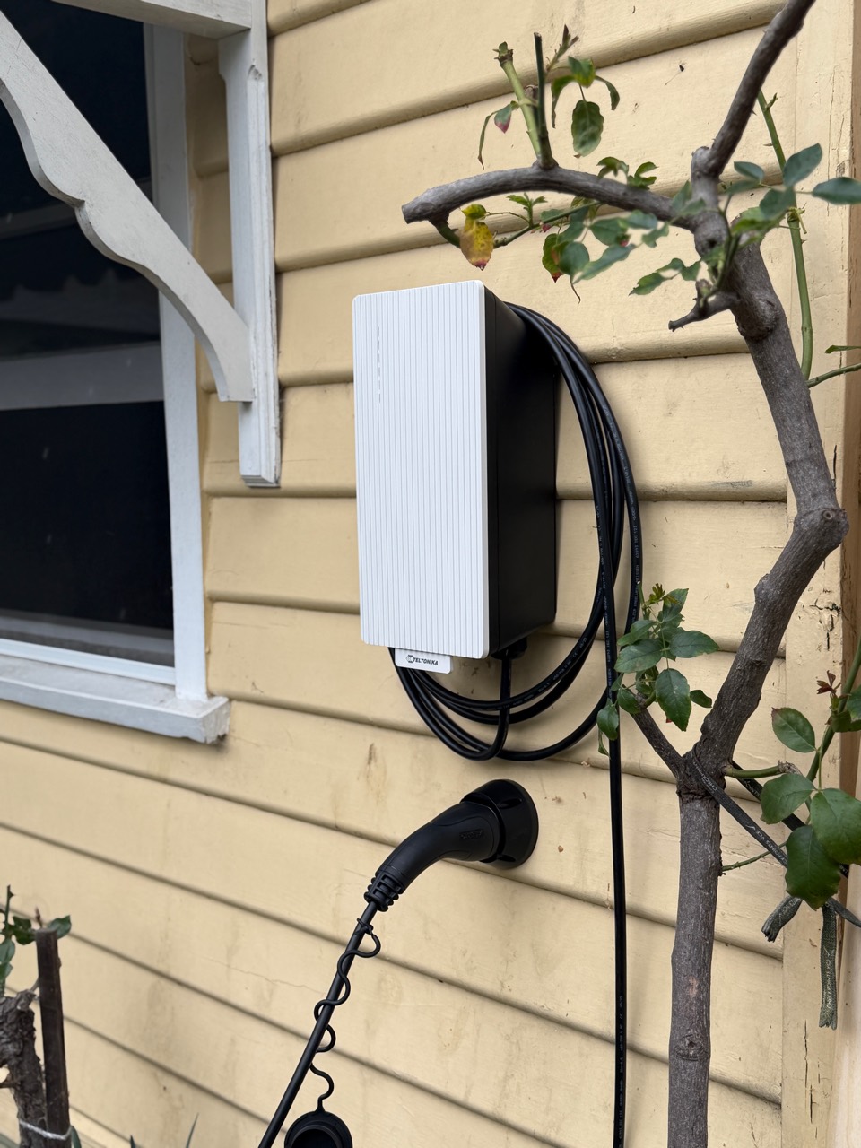 Carbon Group Teltonika EVC2 EV charger installation with a Snow White front plate on a Melbourne weatherboard home