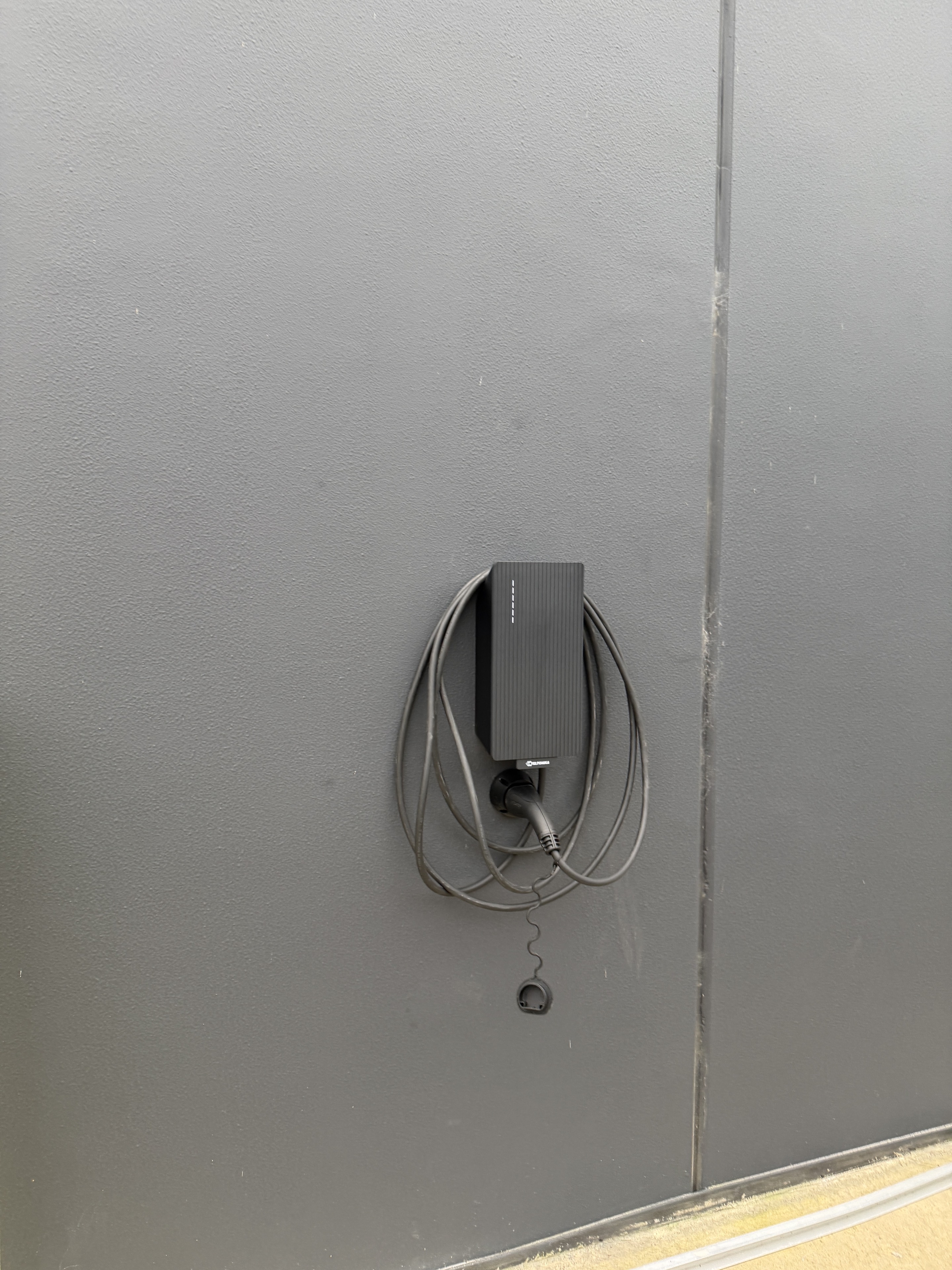 Carbon Group Teltonika EVC2 EV charger installation with an Anthracite Grey front plate on an exterior wall in Melbourne