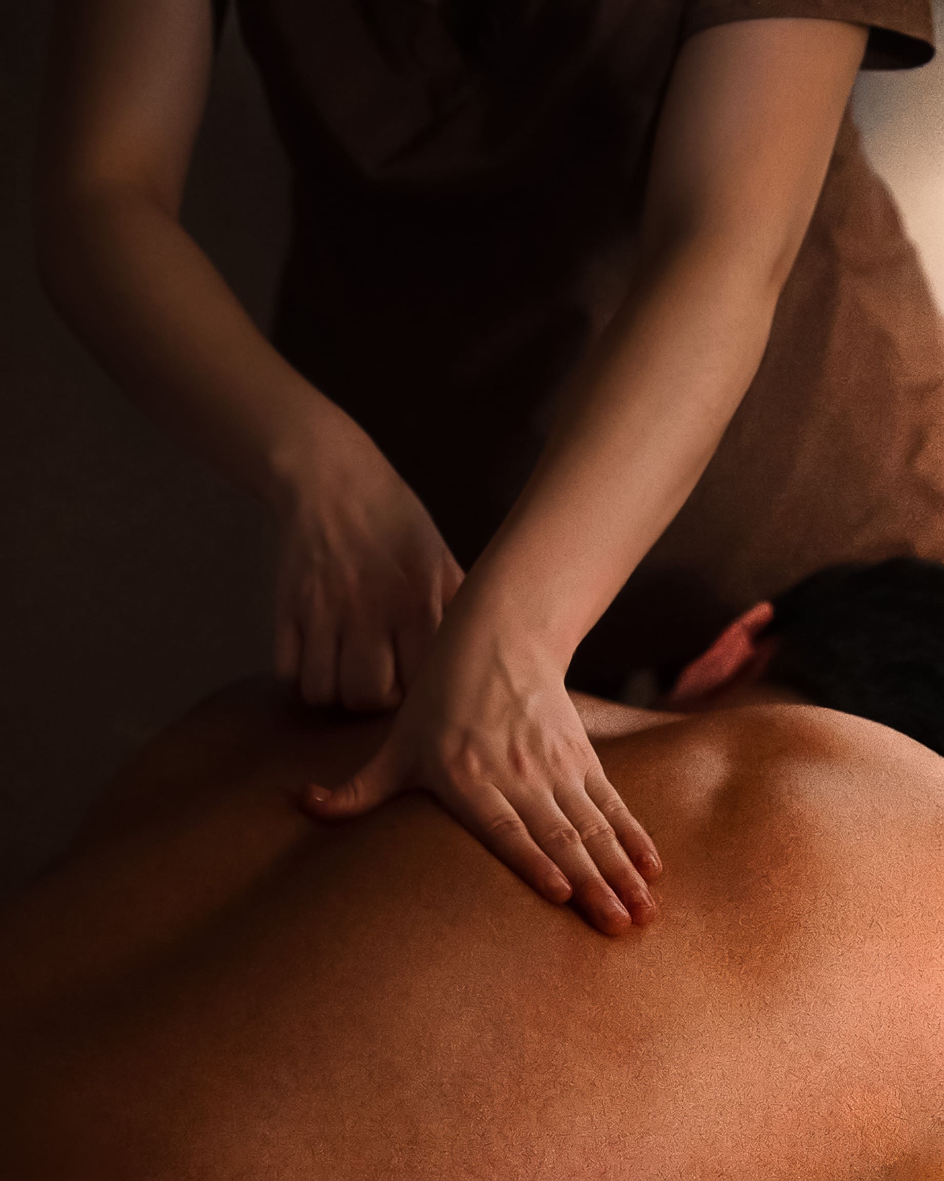 Savia practitioner performing hands-on back work.