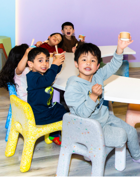 Children eating together at a Minitown table
