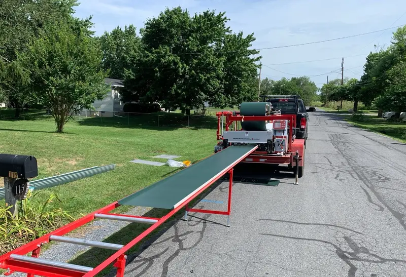 Portable machine producing standing seam roofing panels