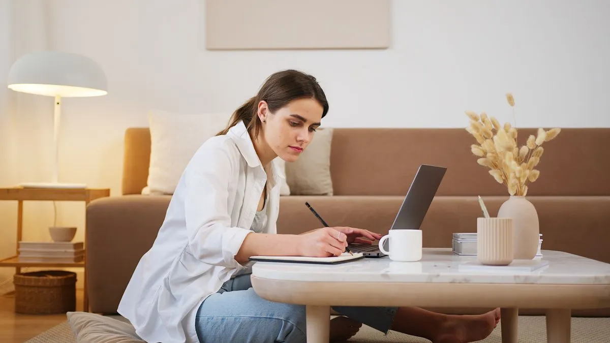 Young person filing a tax return on a laptop with notes