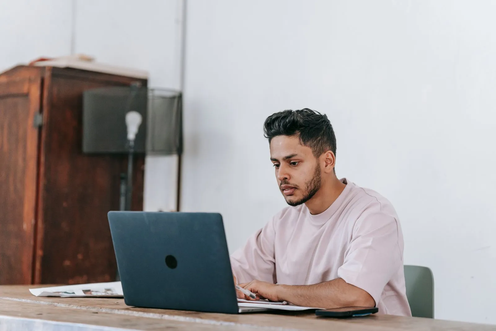 Self-employed freelancer working on a laptop at a home table