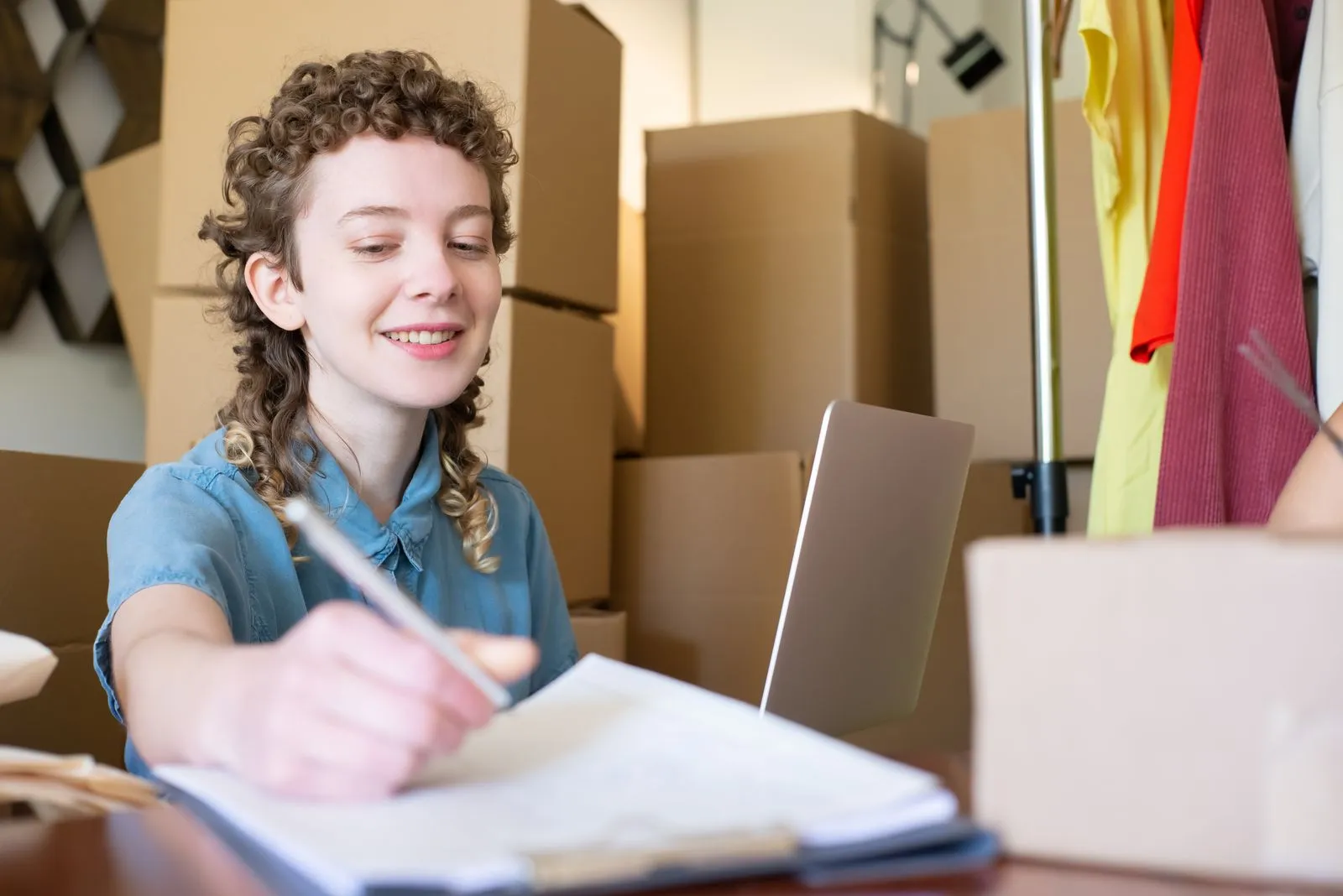 Small business owner managing orders on a laptop in a home office