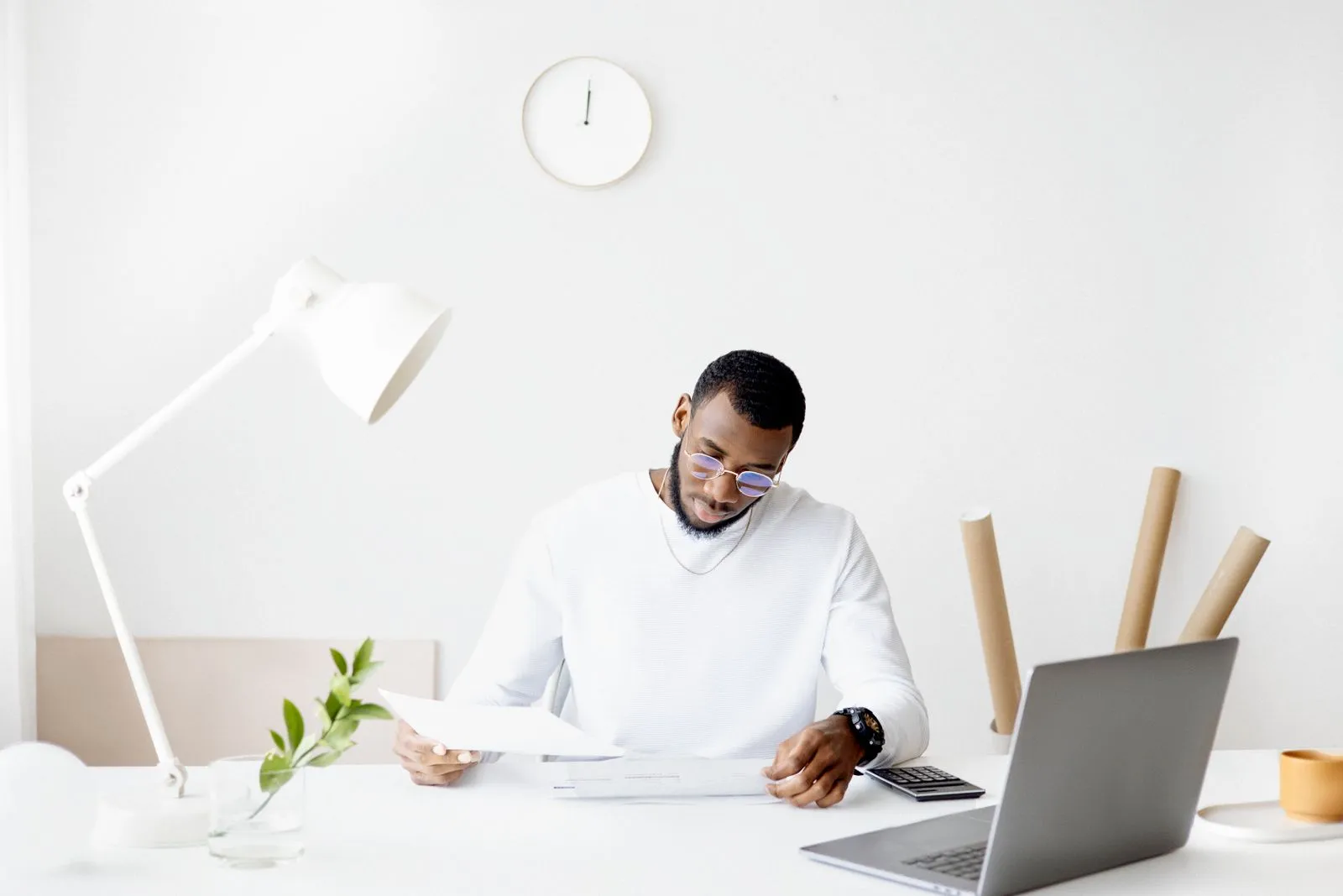 Small business owner reviewing sales tax records on a laptop at home