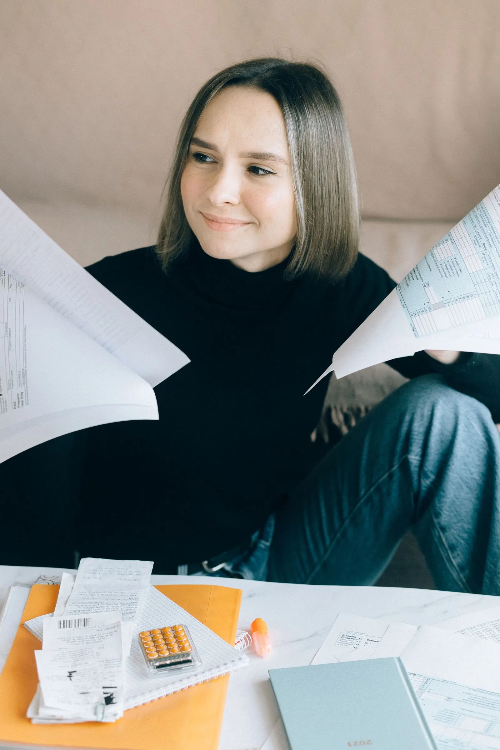 Small business owner reviewing sales tax documents and receipts for filing