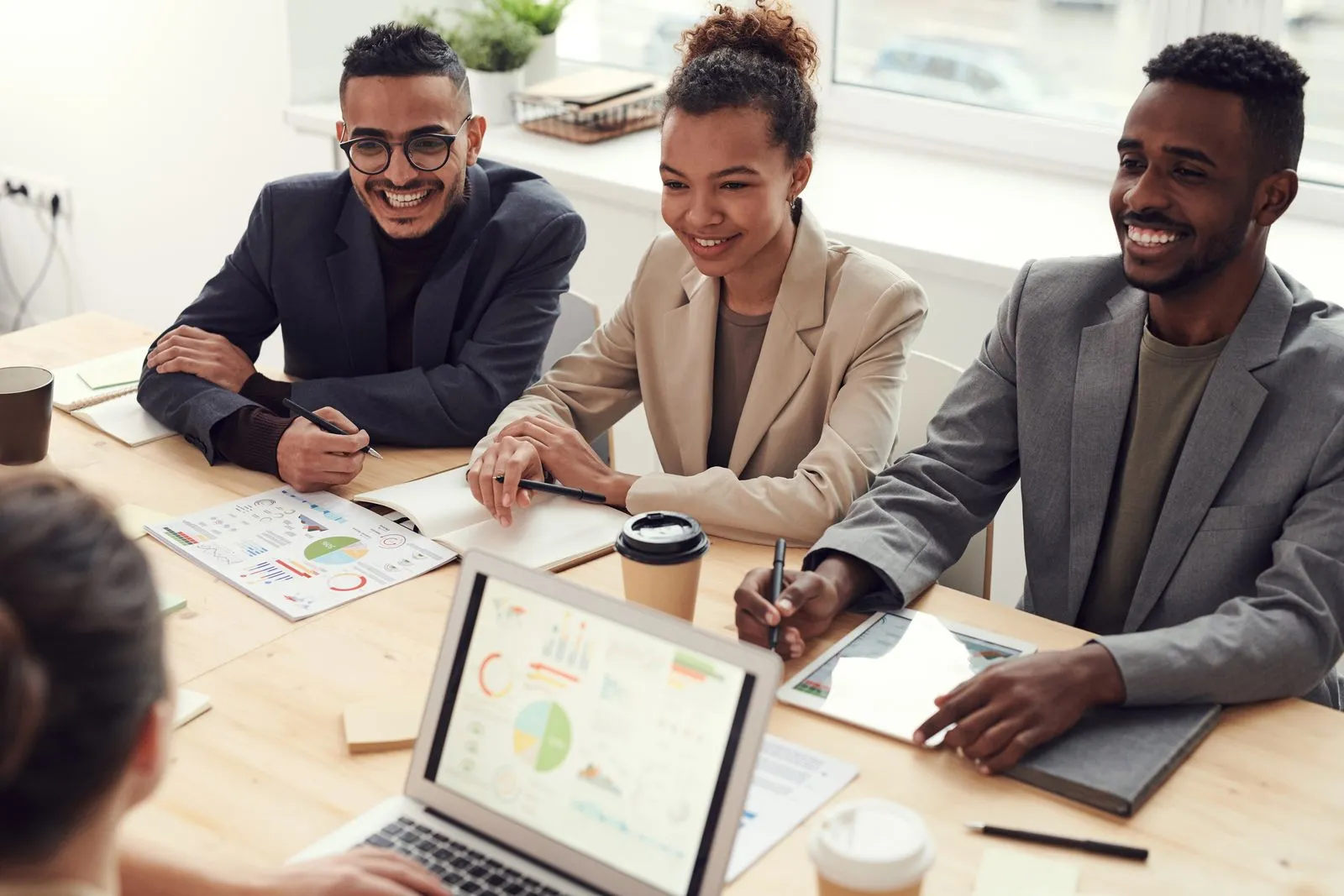 Small business team smiling during a meeting with their accountant in a modern office