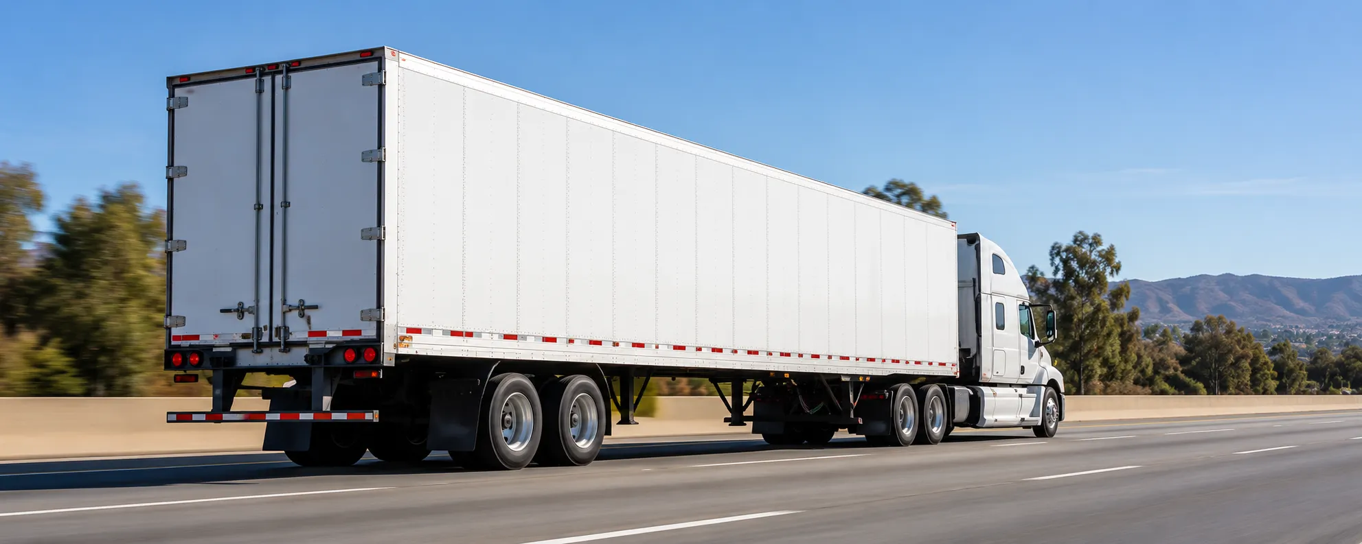 Tractor trailer moving along a highway