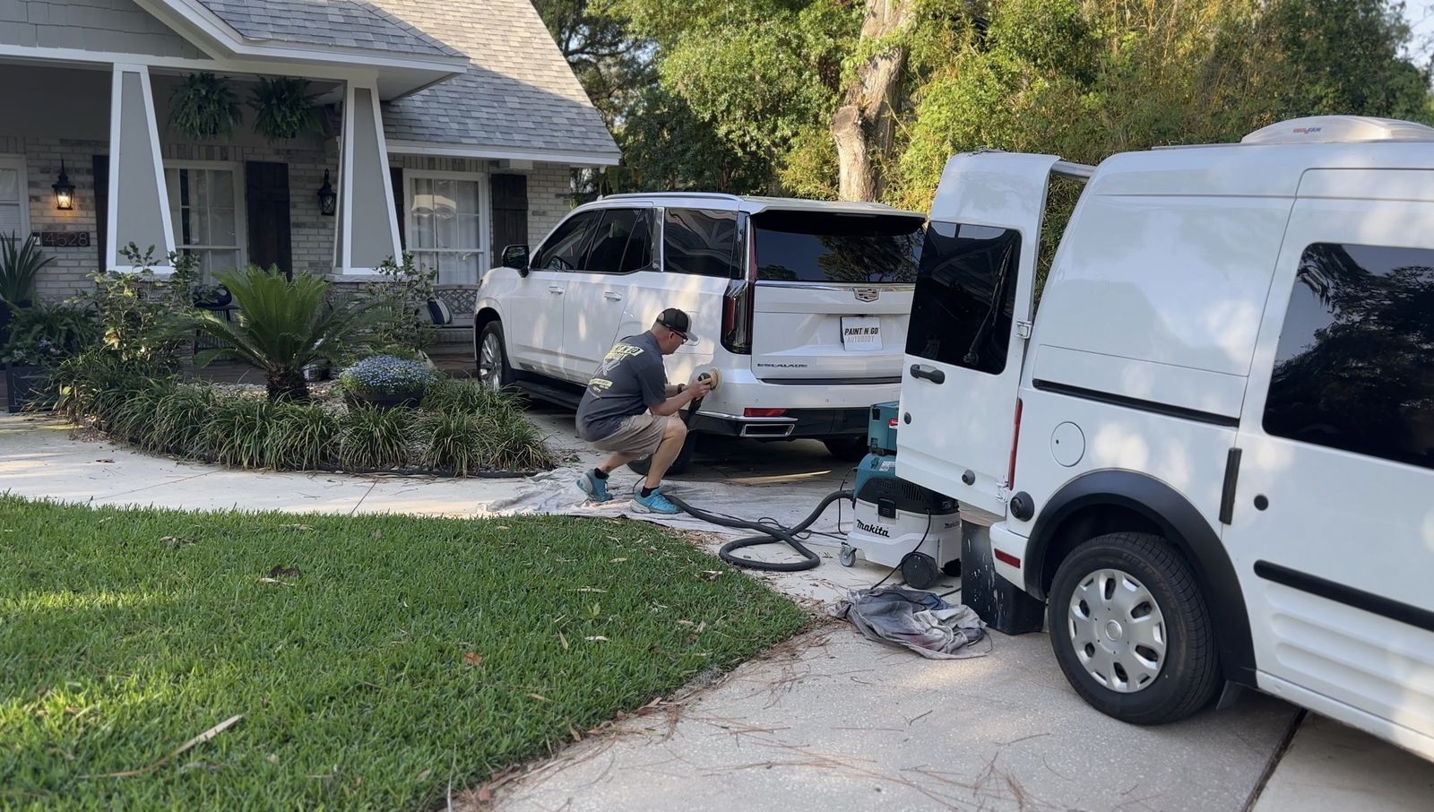 Paint N Go technician completing mobile auto body repair beside a service van