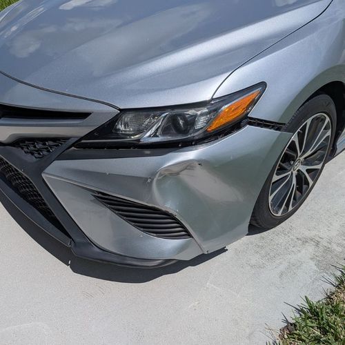 Vehicle with cosmetic front corner damage