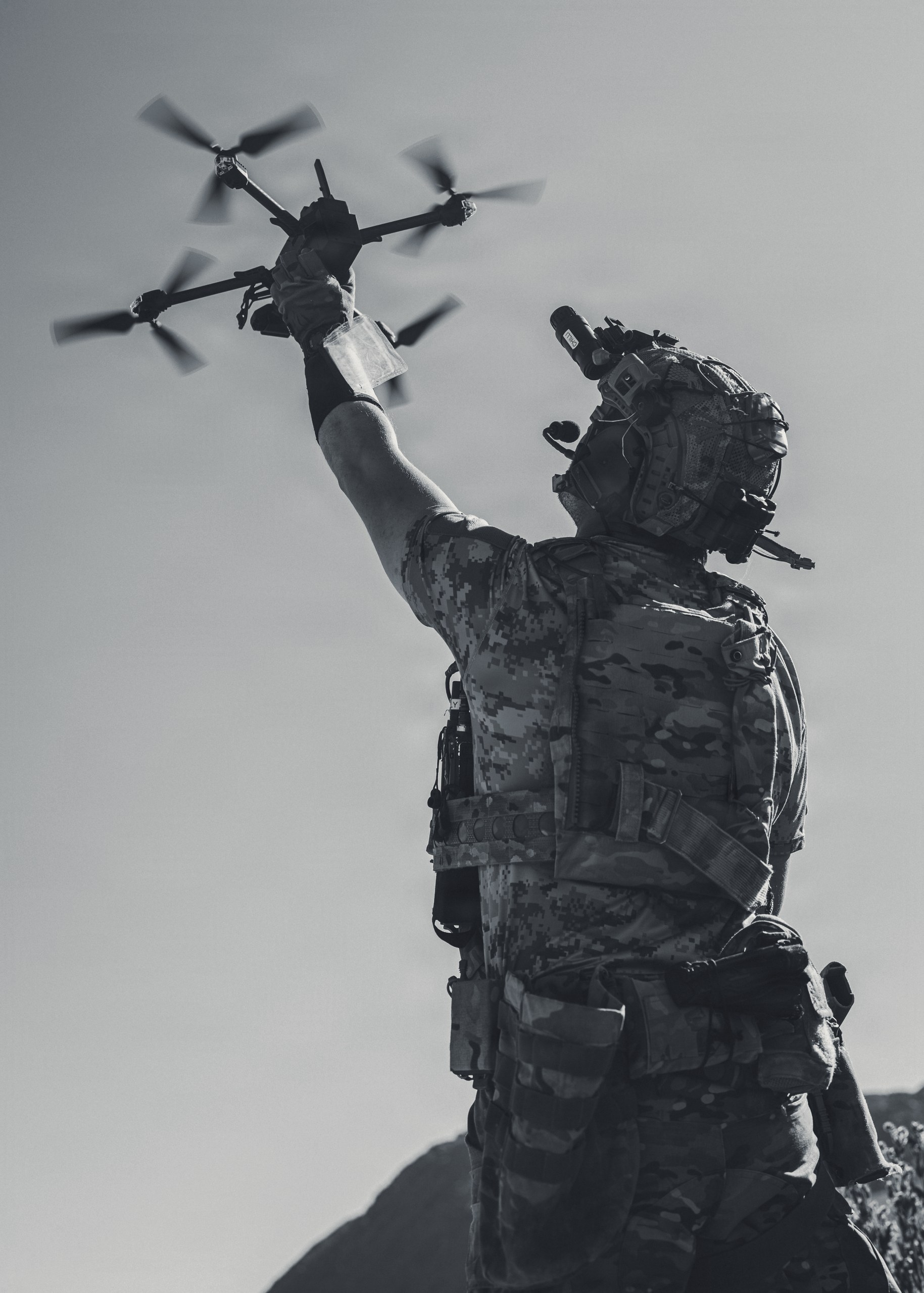 A warfighter launching a drone