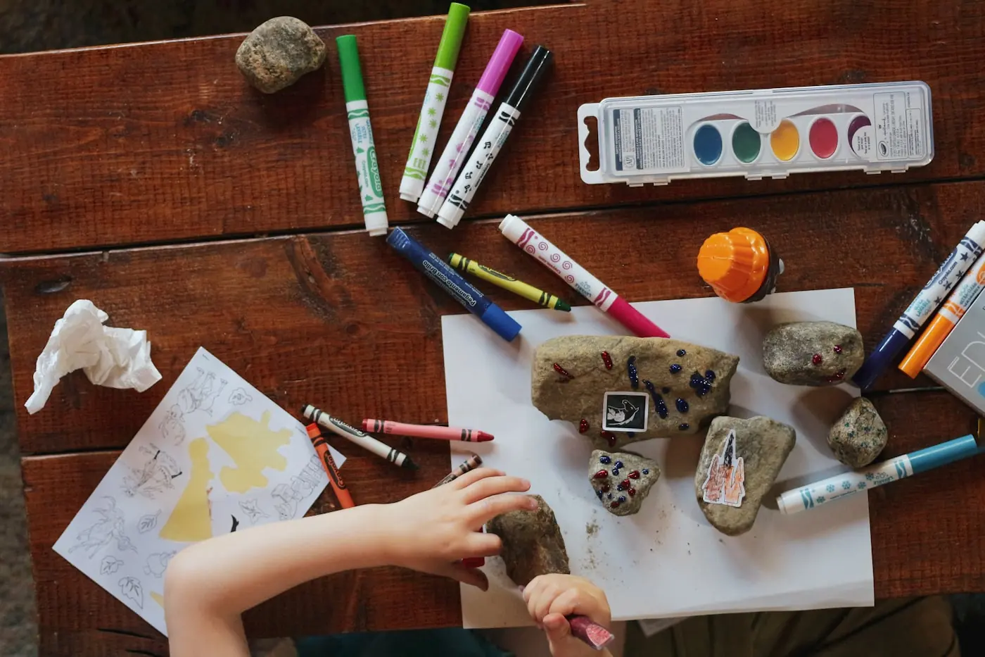 A therapist sitting on the floor working one-on-one with a young child