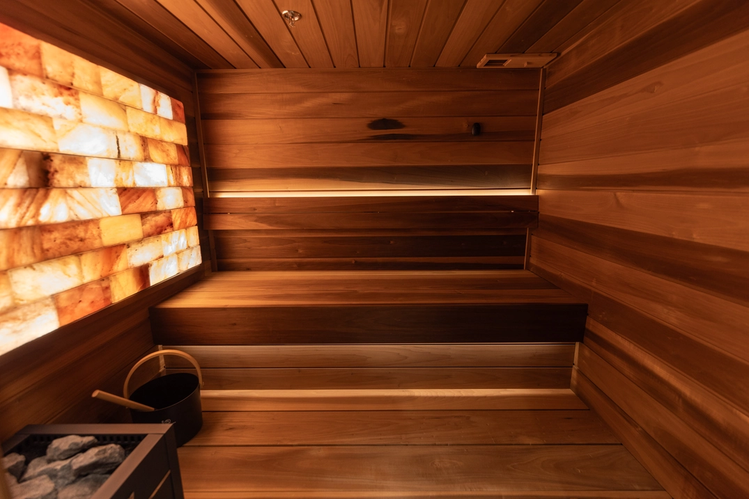 Wide view of tiered cedar benches and illuminated salt wall