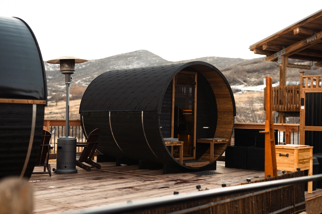 Pair of black barrel saunas on the Soldier Hollow deck