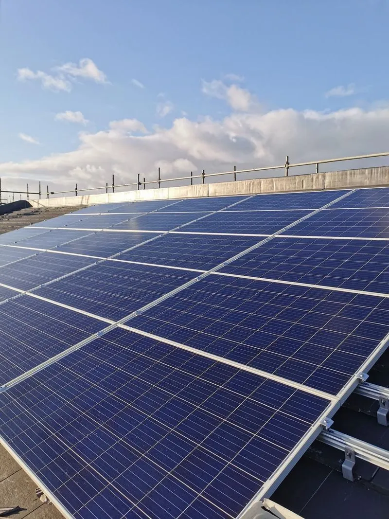 Close-up of installed solar panels against a clear sky