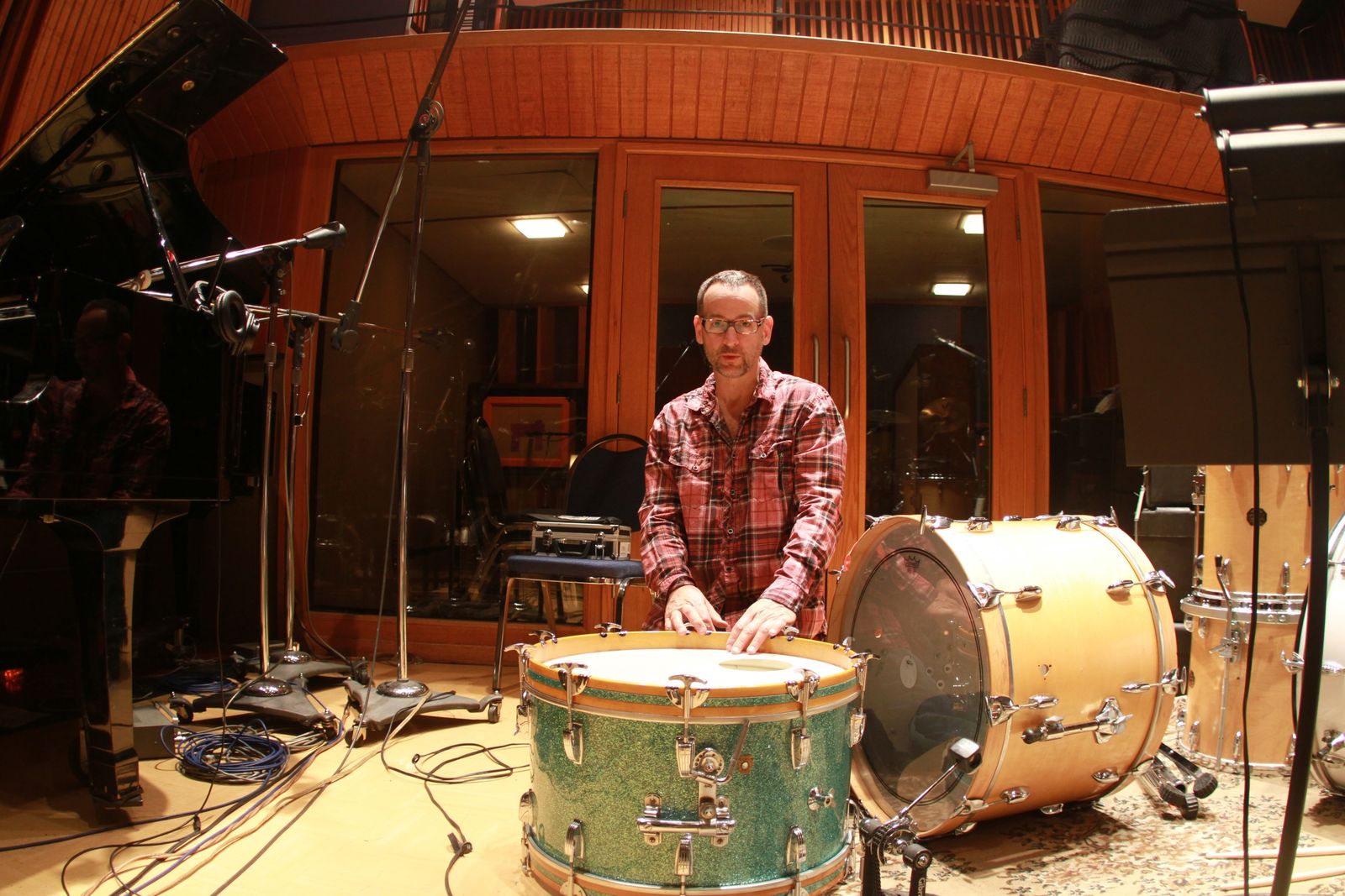 Jerry Johnson tuning a drum in the studio