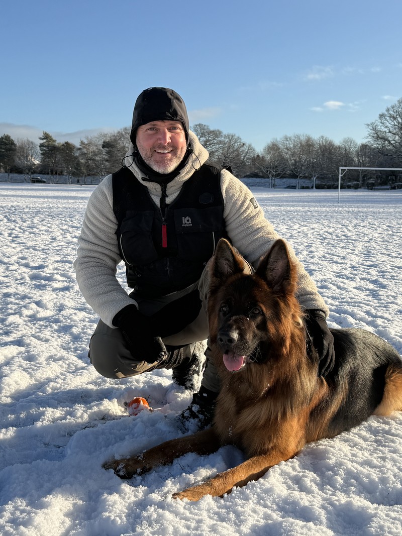 Scott McKay with his German Shepherd Puro in the snow