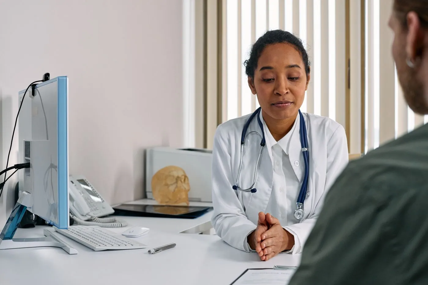 Clinician speaking with a patient during an eye-care consultation
