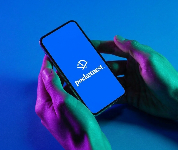 Hands holding a phone showing the Pocketnest app logo