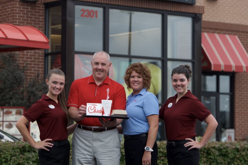 Oscar Fittipaldi and his team outside his Chick-fil-A restaurant