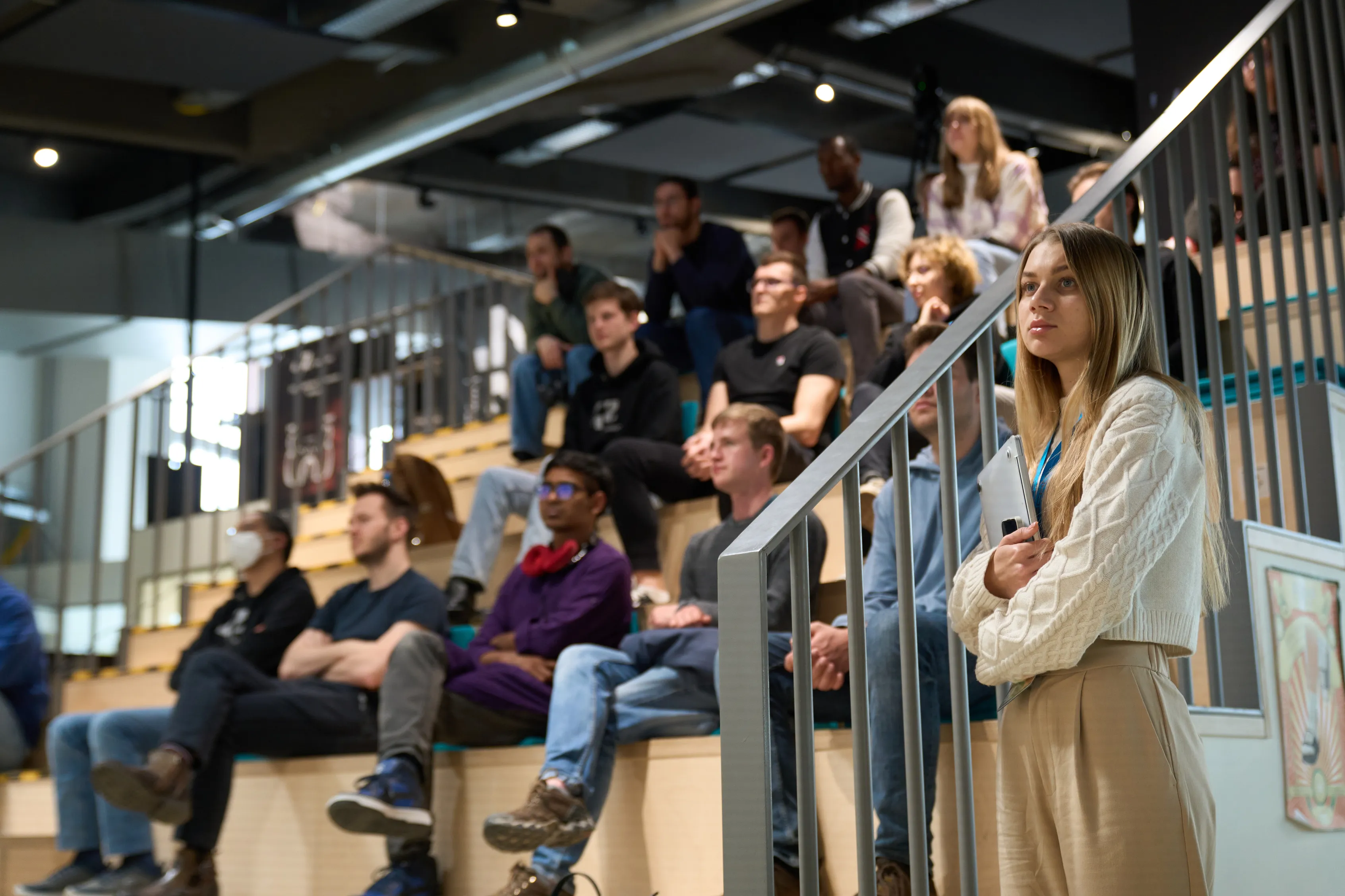 An audience watching a talk on the campus bleachers