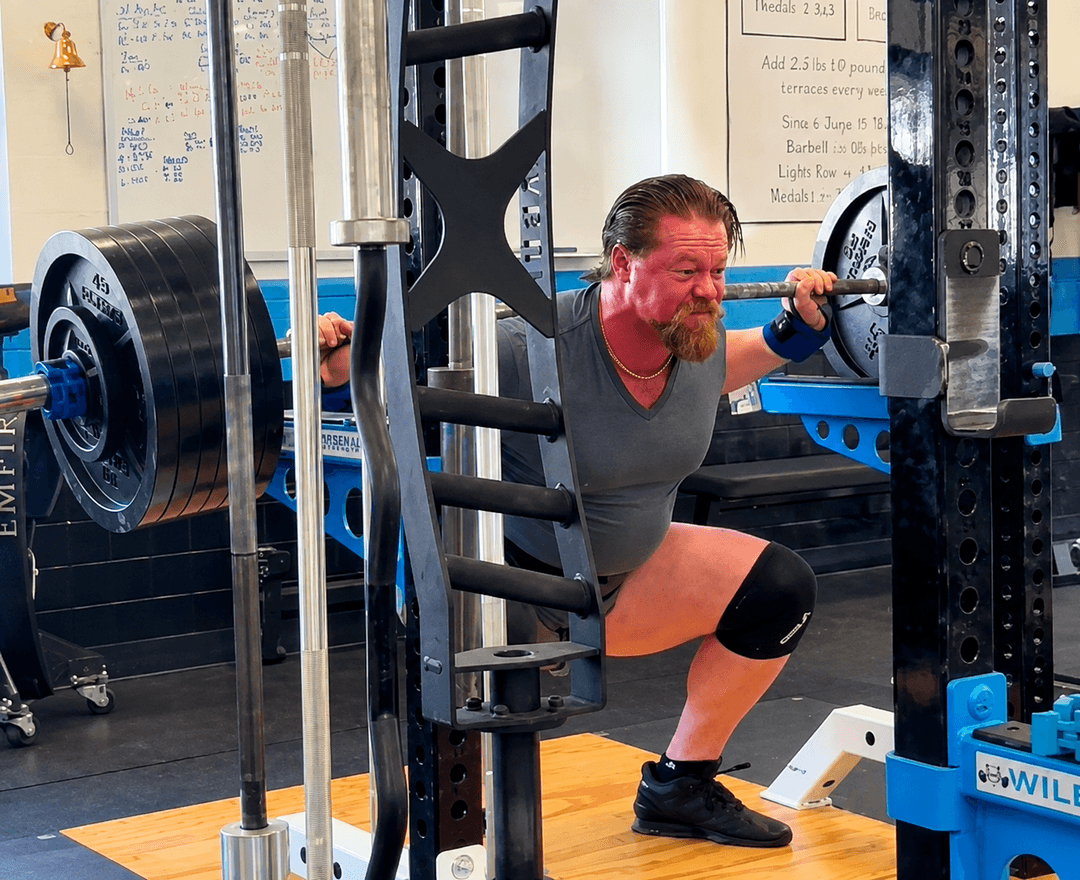 Cameron Cox squatting 605 pounds in the rack at The Strength Club in Charleston, SC