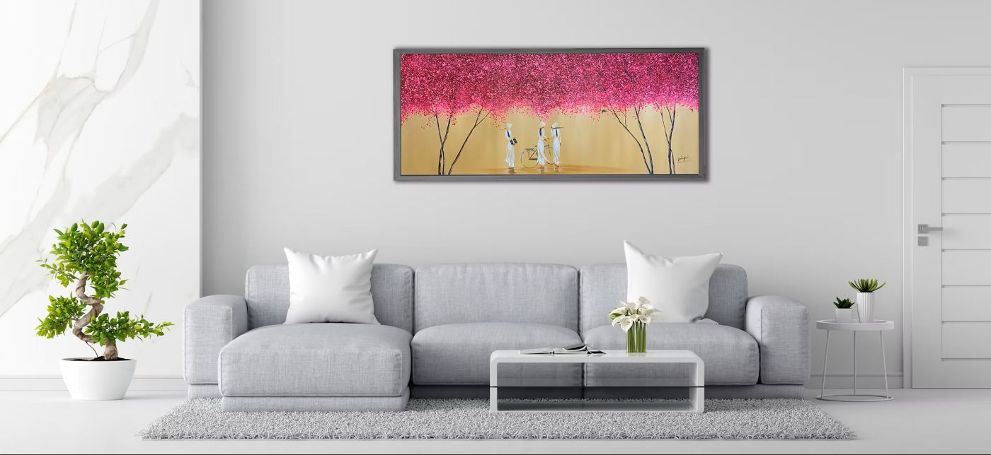 A wide blossom painting above a sofa in a living room