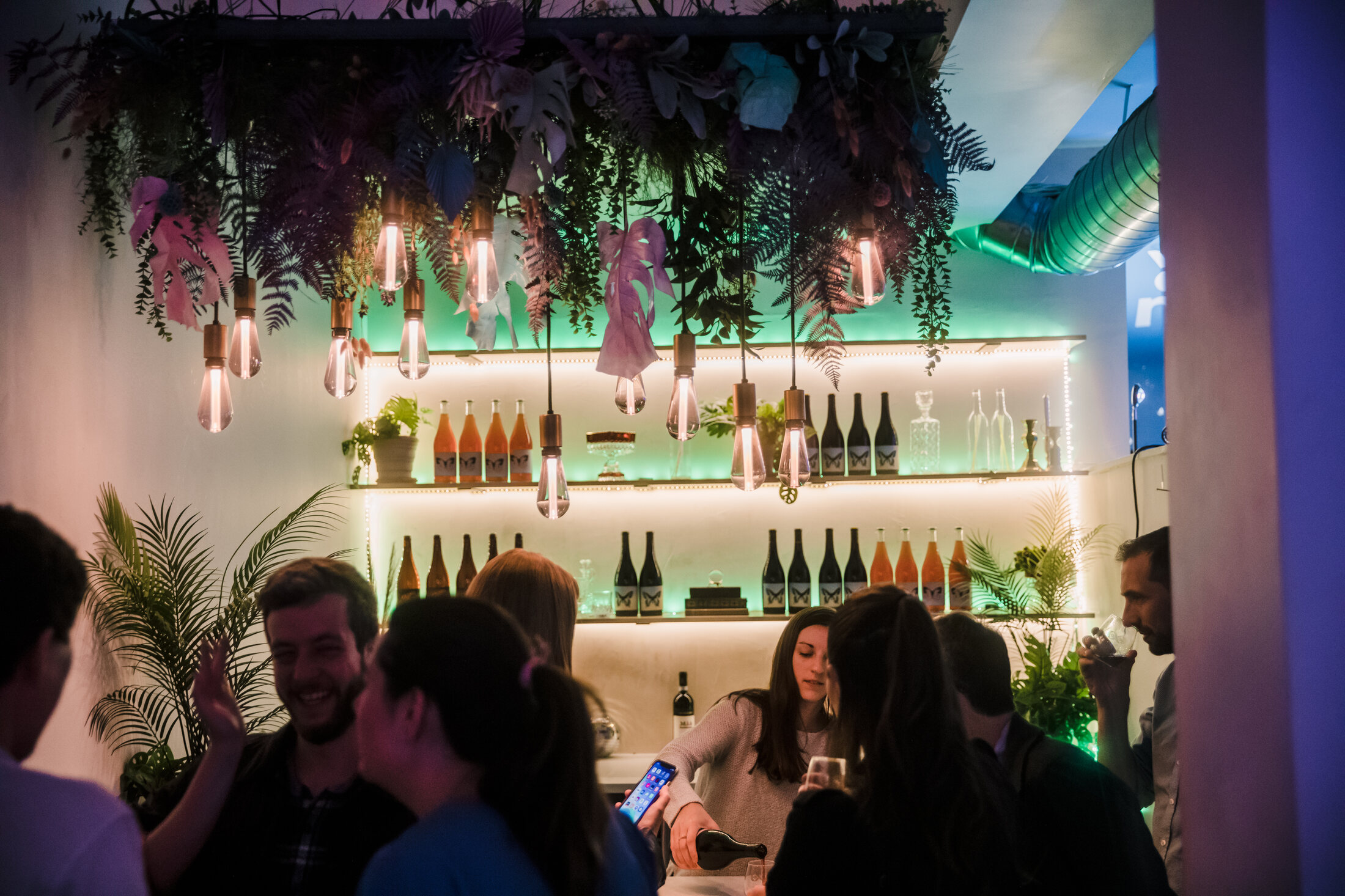 Guests gathering around the cocktail bar
