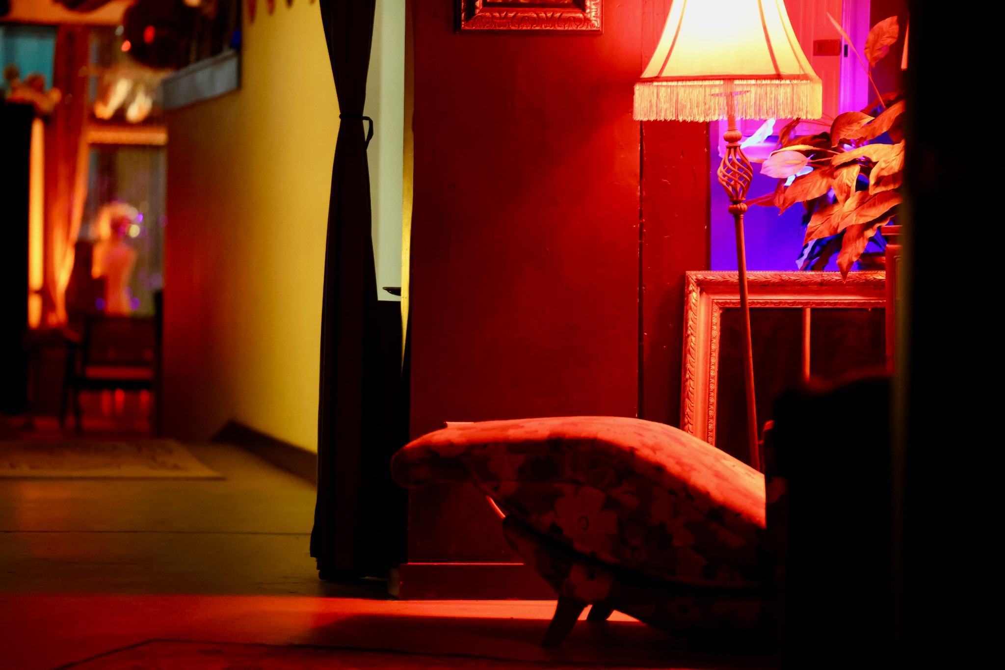 Vintage lounge chair beside a glowing fringed lamp