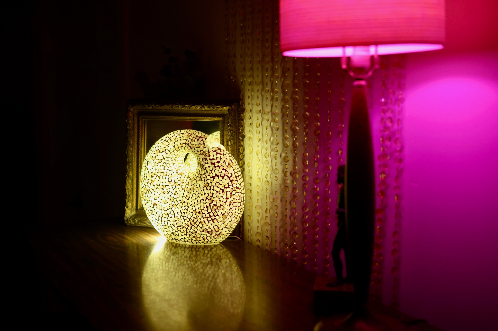Mosaic lamp and bead curtain in warm evening lighting