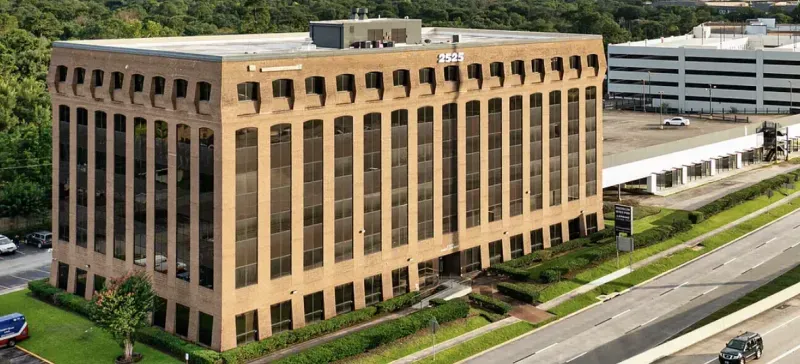 Aerial view of commercial office building and parking garage