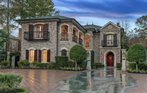 Stone and brick estate exterior with arched entry