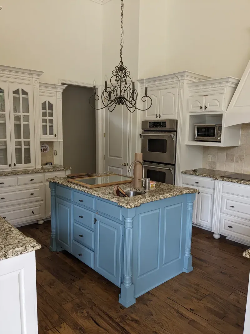 Custom kitchen with blue island and white cabinetry