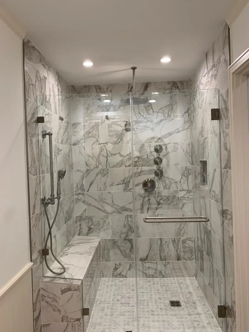 Marble shower with rain showerhead and grab bar