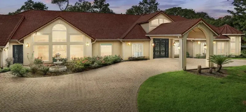 Mediterranean-style estate exterior with red tile roof