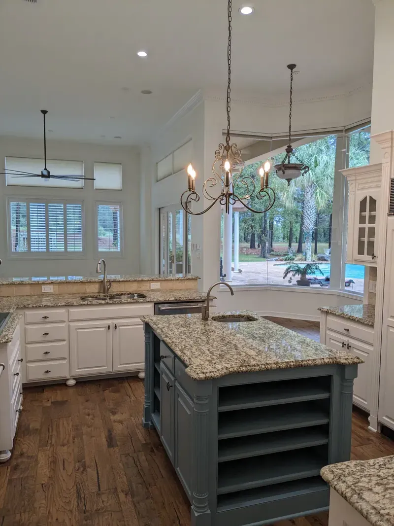 Custom kitchen island with open shelving and pool view