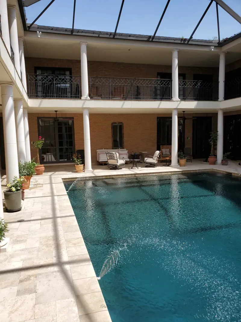 Custom estate courtyard pool with covered colonnade